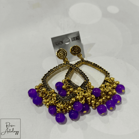 JHUMKA'S PURPLE RA-2 EARRINGS featuring a stunning design with gold accents and vibrant purple beads.