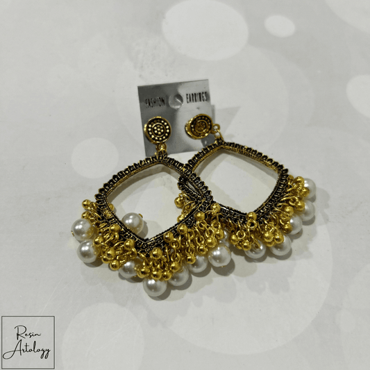 JHUMKA'S WHITE RA-2 EARRINGS featuring intricate gold design with pearl accents.
