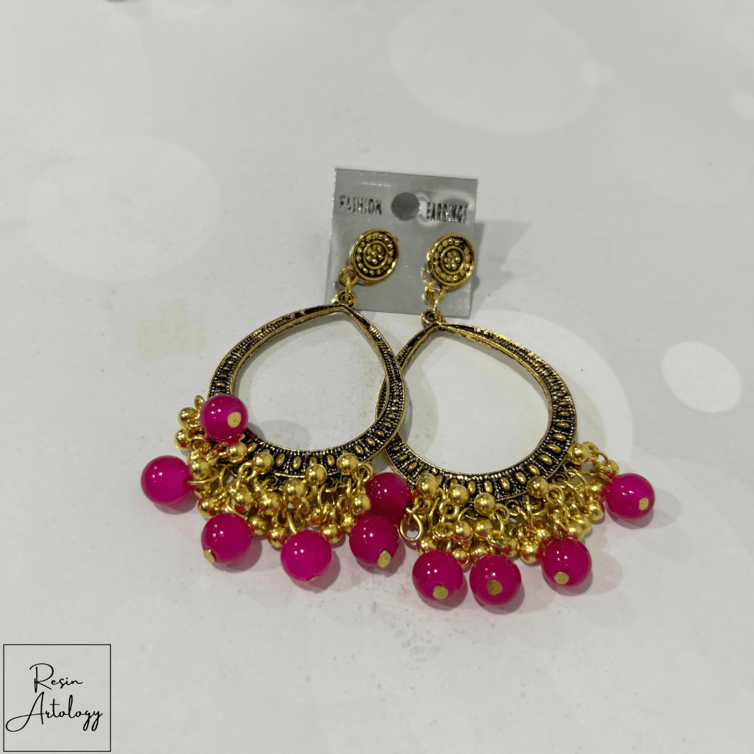 JHUMKA'S MAGENTA PINK RA-3 earrings showcasing vibrant magenta pink beads and intricate gold detailing.