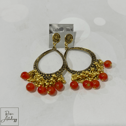 JHUMKA'S ORANGE RA-3 earrings featuring a traditional design with vibrant orange beads and an antique gold finish.