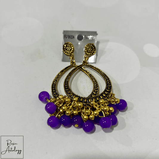 JHUMKA'S PURPLE RA-3 earrings featuring intricate gold design and vibrant purple beads.
