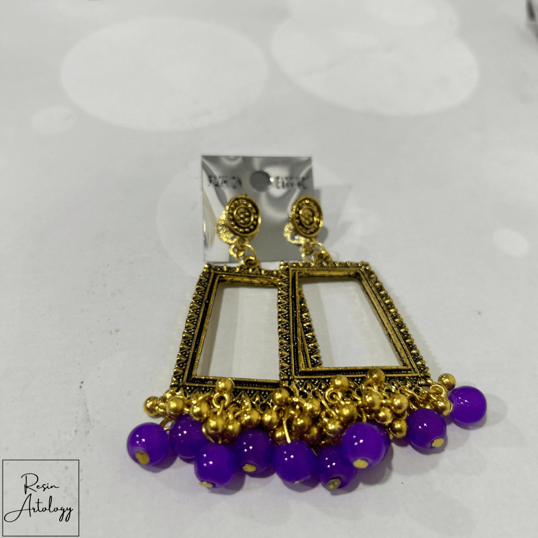 JHUMKA'S PURPLE RA - 4 EYERING featuring a stunning purple design with gold accents, perfect for elegant occasions.