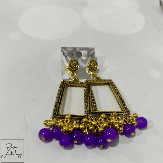 JHUMKA'S PURPLE RA - 4 EYERING featuring a stunning purple design with gold accents, perfect for elegant occasions.
