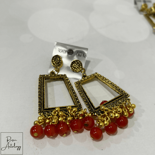 JHUMKA'S ORANGE RA-4 earrings featuring vibrant orange hue and traditional Indian design with modern appeal.