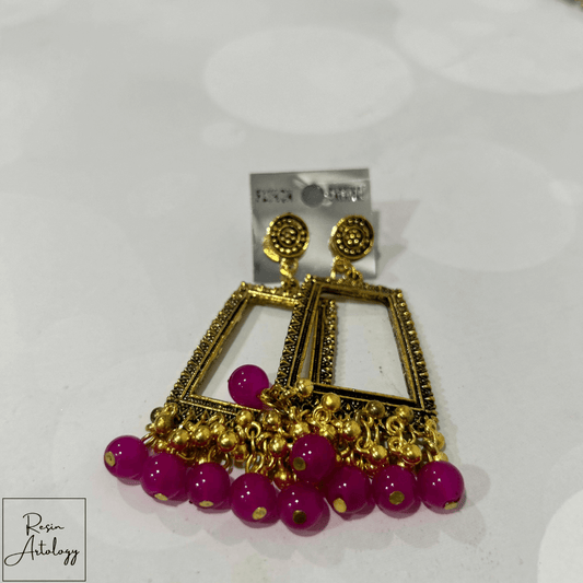 JHUMKA'S MAGENTA PINK RA-4 earrings featuring gold frame and magenta beads, perfect blend of tradition and style.