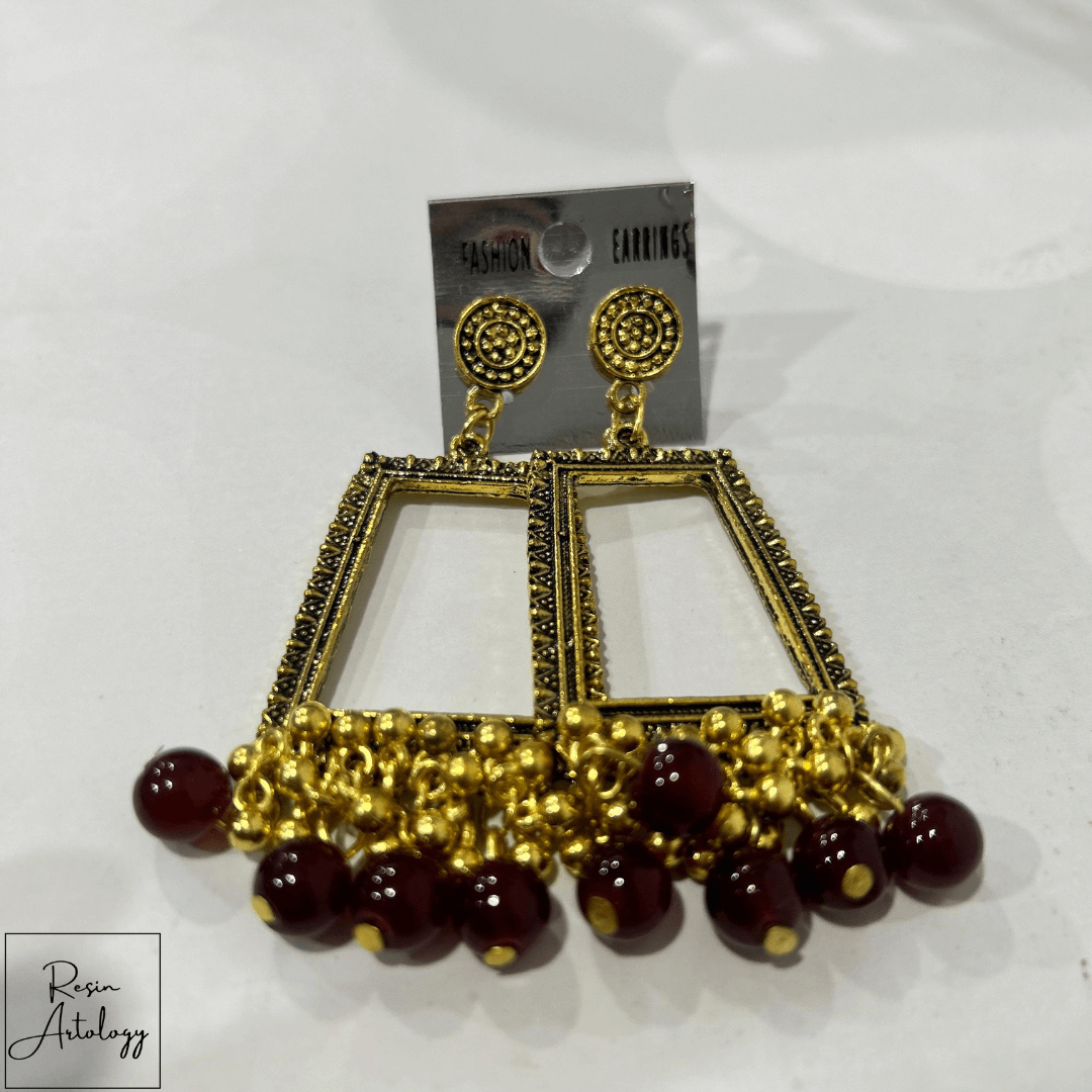 JHUMKA'S MARUN RA-4 earrings with gold detailing and maroon beads for a traditional yet contemporary look.