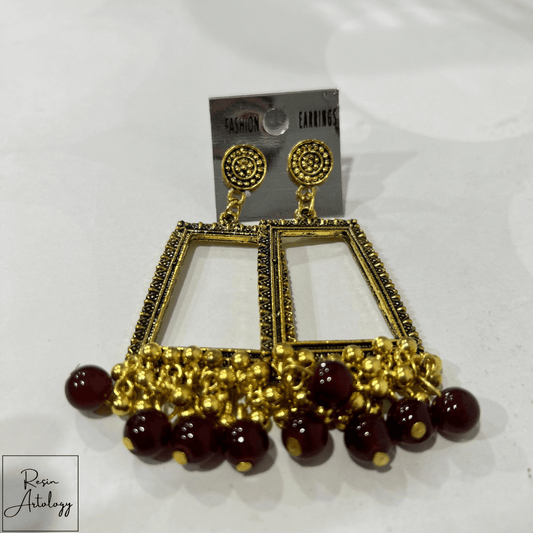 JHUMKA'S MARUN RA-4 earrings with gold detailing and maroon beads for a traditional yet contemporary look.